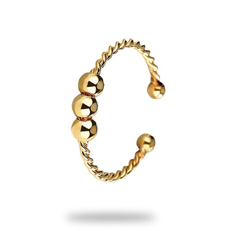 Trio, une bague ouverte avec trois billes mobiles sur un anneau torsadé